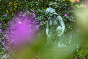 Mourning woman statue, rhododendron blossom, Ohlsdorf cemetery, Hamburg, Mourning woman statue, rhododendron blossom, Ohlsdorf cemetery, Hamburg,